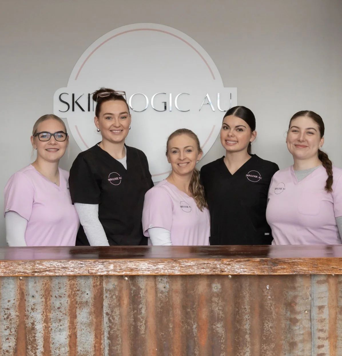 The Skin Logic AU team behind the reception desk